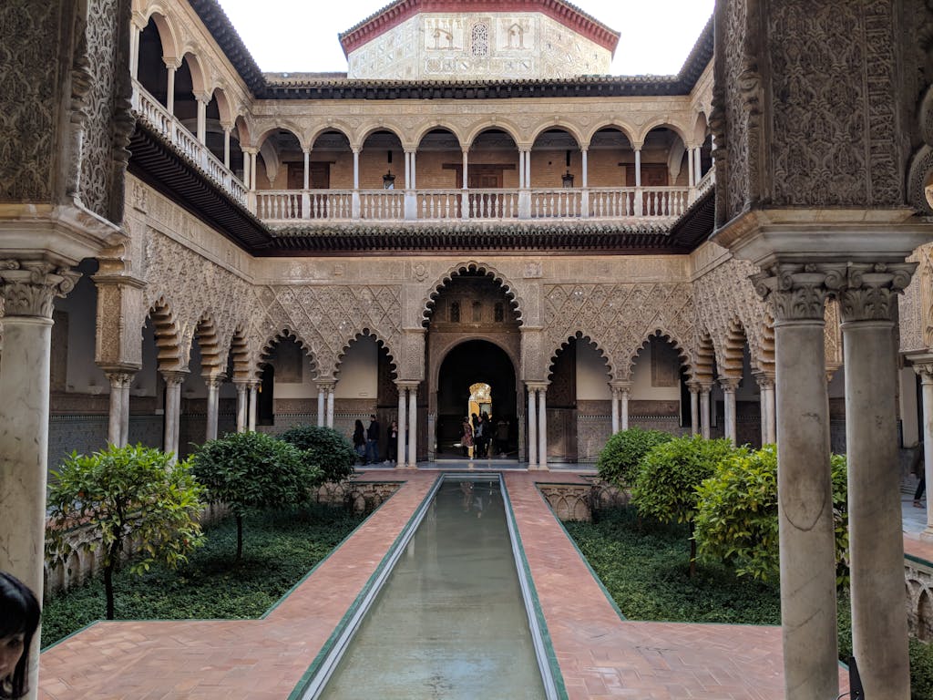 Historic courtyard in the Alcázar of Seville showcasing exquisite Moorish architecture.