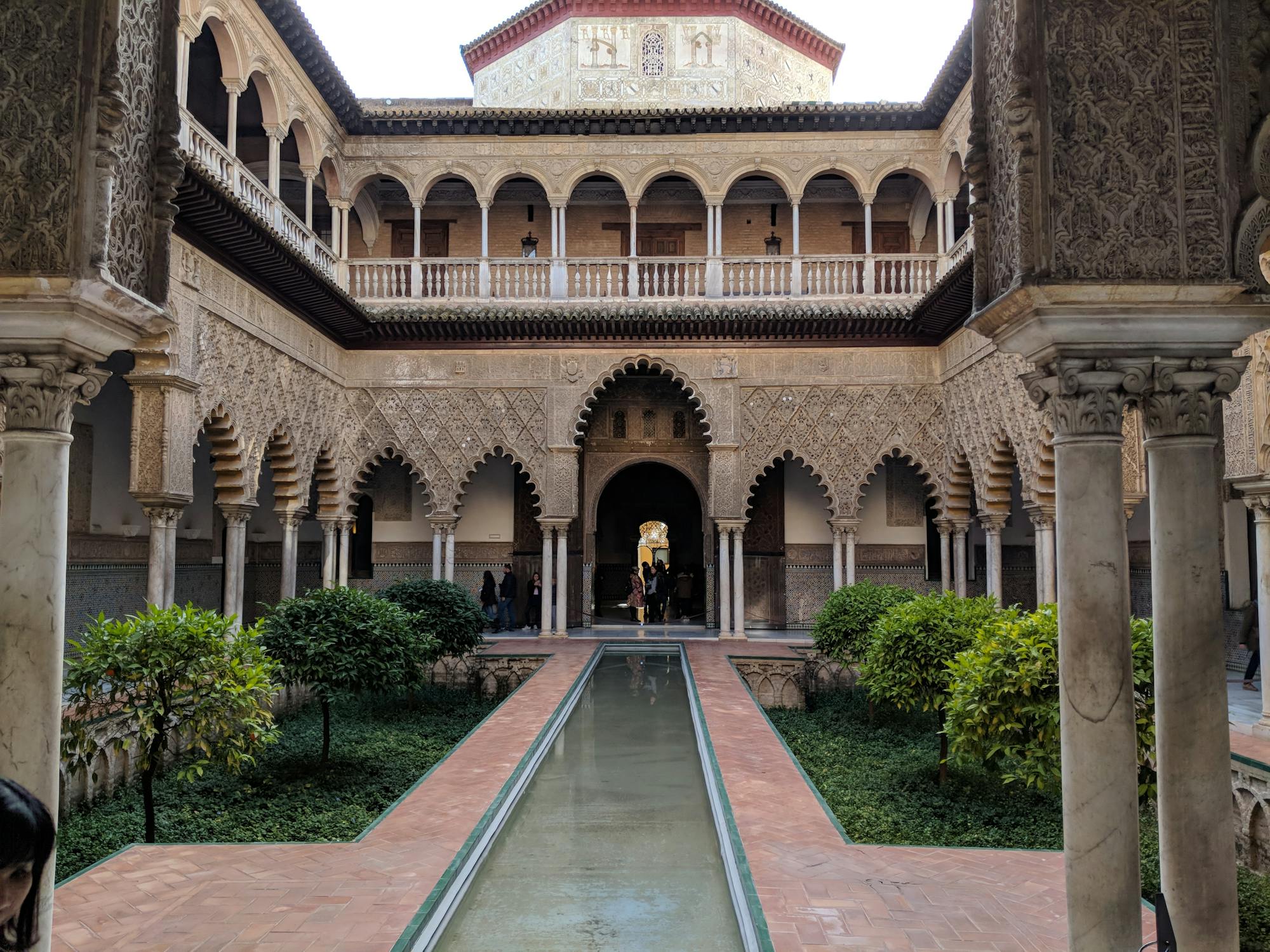 Historic courtyard in the Alcázar of Seville showcasing exquisite Moorish architecture.