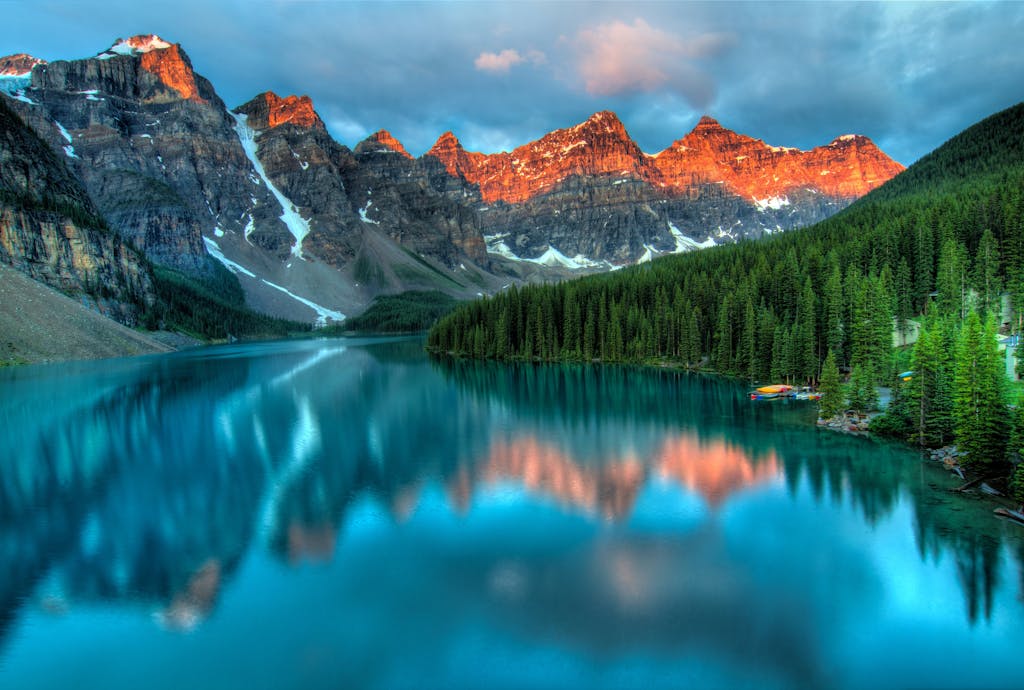 Capture the serene beauty of Moraine Lake with sunrise reflections in Banff National Park. You should add this location to your banff itinerary.